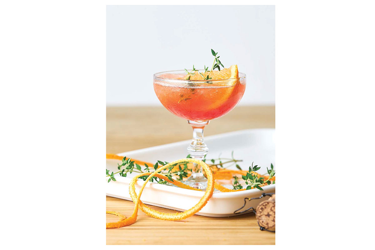orange cocktail with herbs