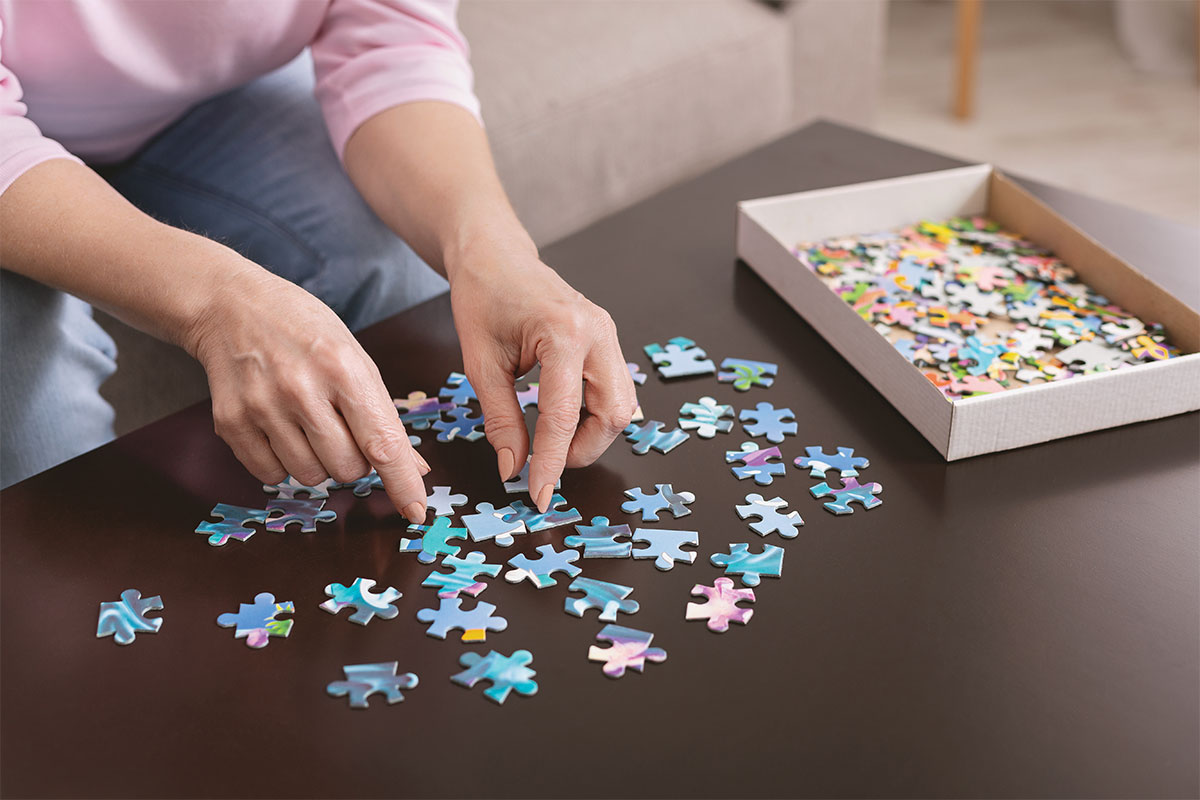woman putting together a puzzle