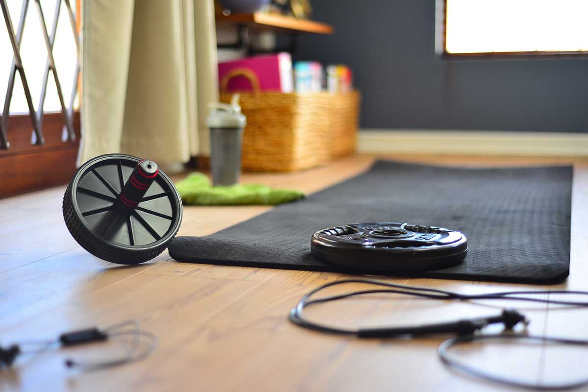 workout equipment at home with jump rope, weight, and yoga mat