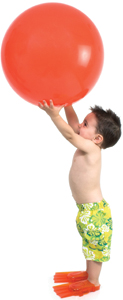 Adorable Boy Ready To In Swim Gear With Giant Orange Ball Over W