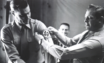Rockwell, left, putting on a swastika 