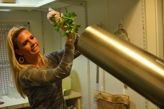 Antonelli Feeding Vegetables into a Juicer / Photo Courtesy of Greenleaf Juicing Company