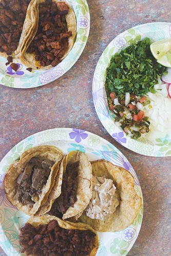 (From top left) From Jarochita #2: al pastor; garnishes of cilantro, spicy tomato and pickled chile salsa, onions and sliced radishes; lengua cabeza, sesos and al pastor tacos / Photo by Ann Hsu Kaufamn