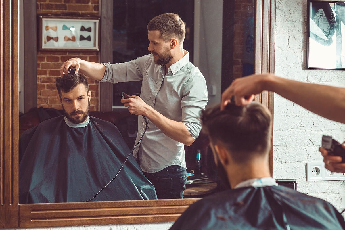 man-having-hair-cut-at-barber-shop