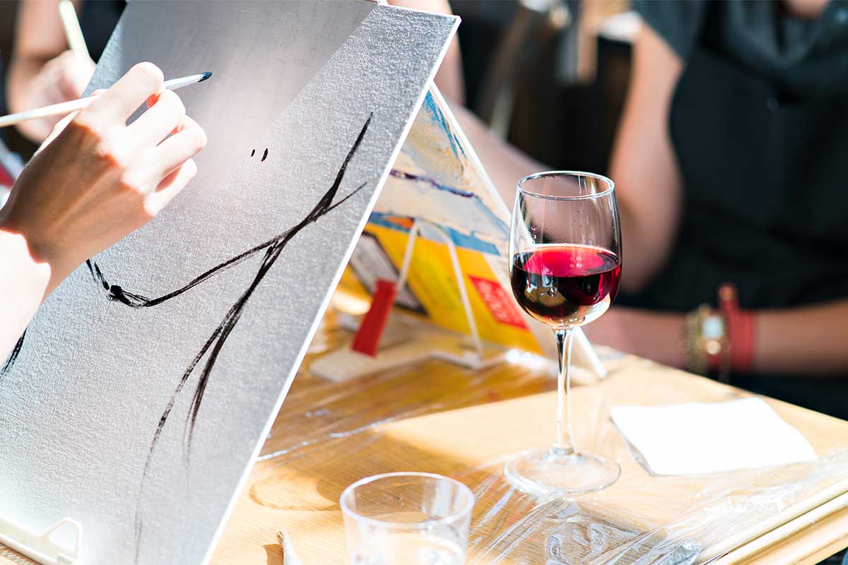 person painting with wine