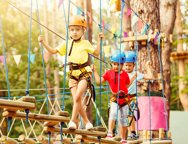 kids walking a tight rope course at summer camp