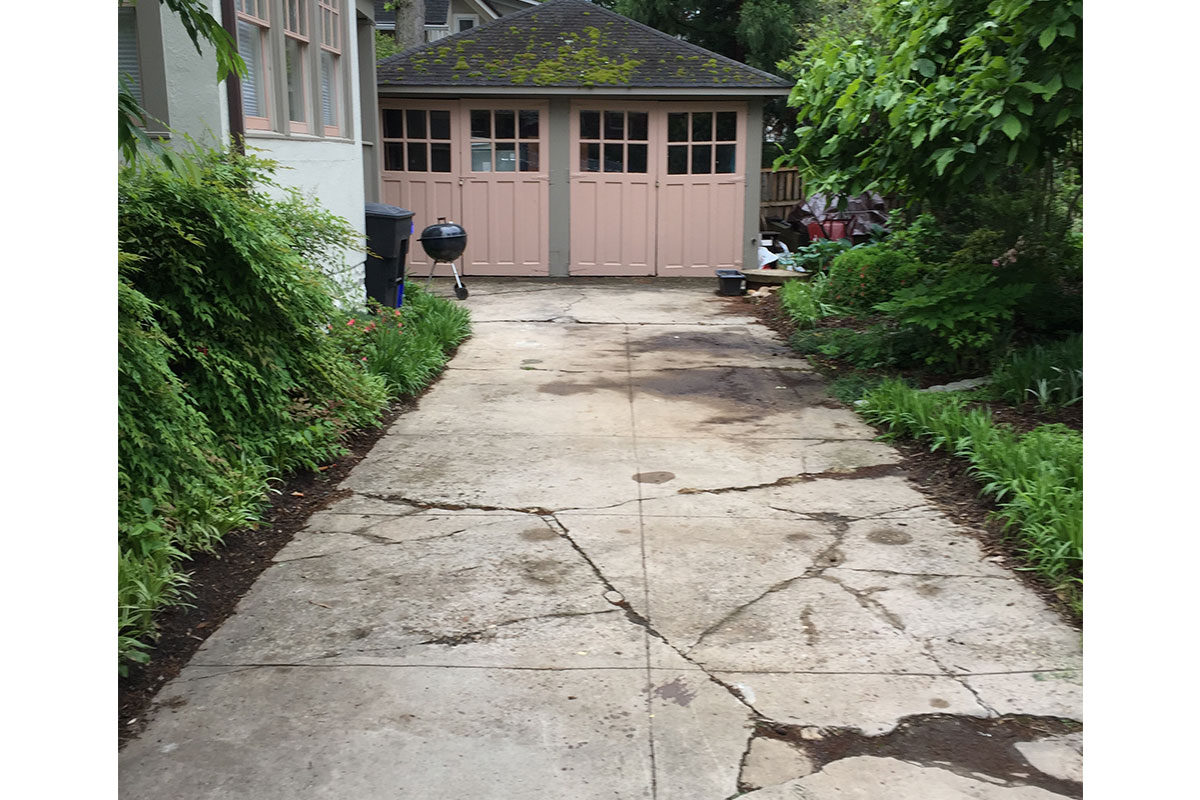 ugly cracked driveway with pink garage in arlington