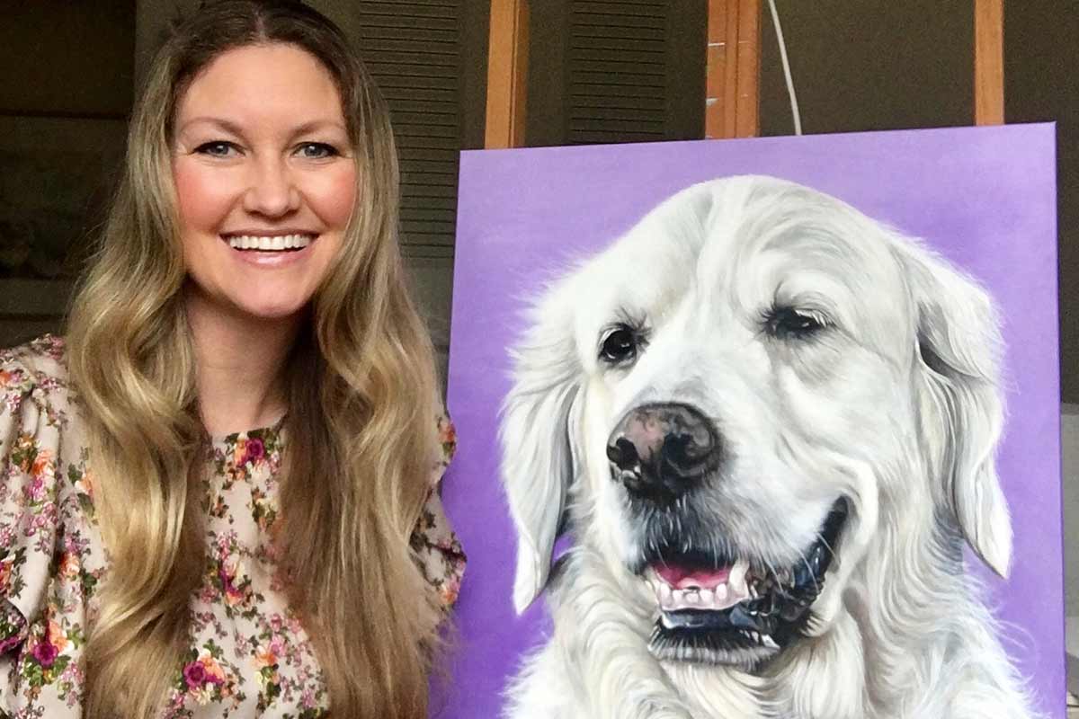 artist with painting of white dog