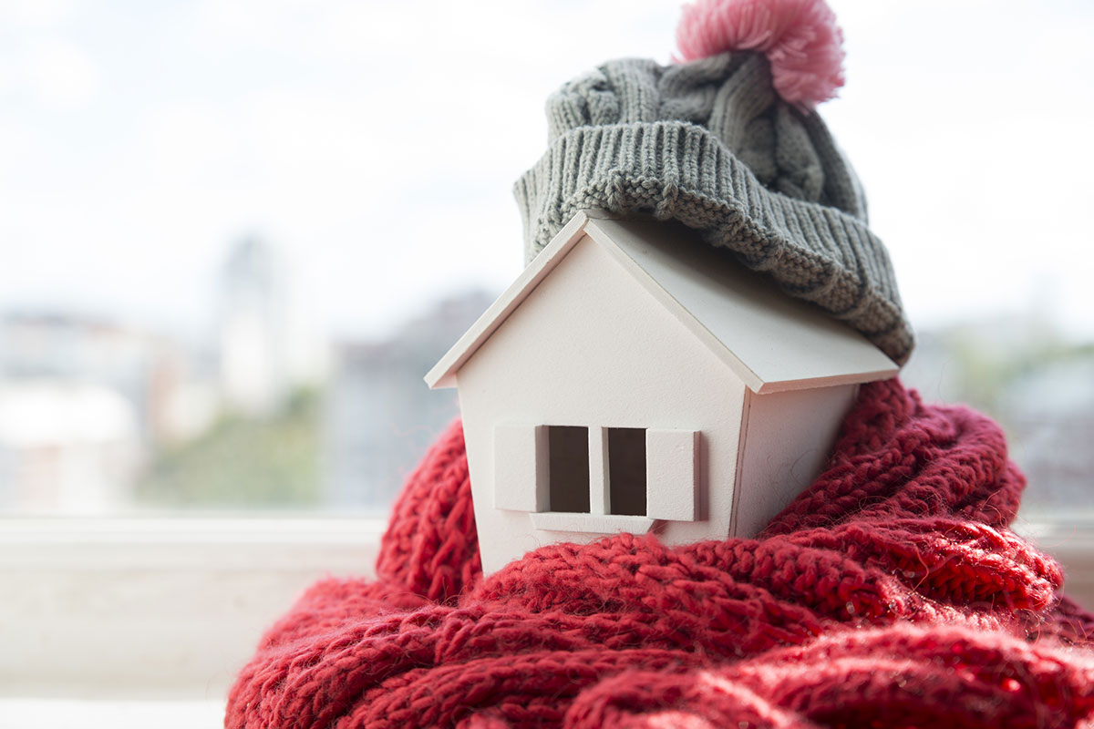 model small house with winter scarf and hat