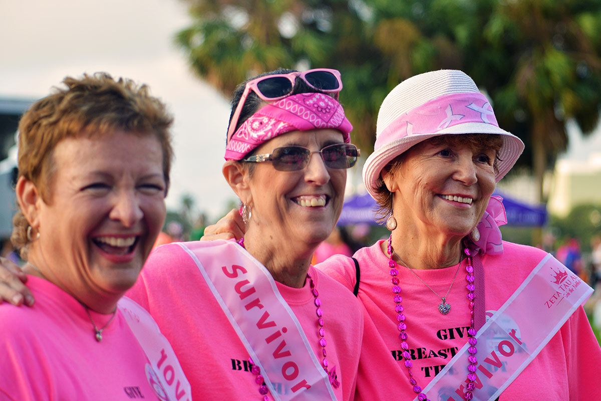 three women in pink smiling
