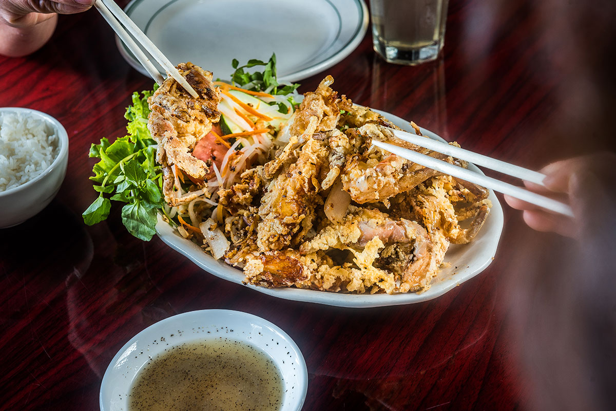 fried meat on plate with chopsticks