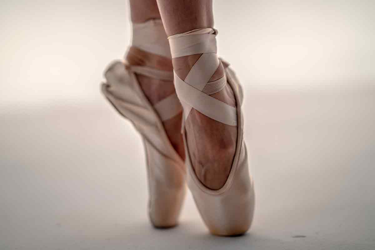 feet pointed in ballet slippers