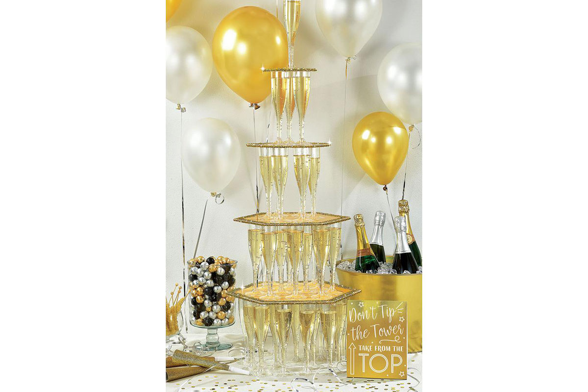 champagne tower with gold and white balloons in back