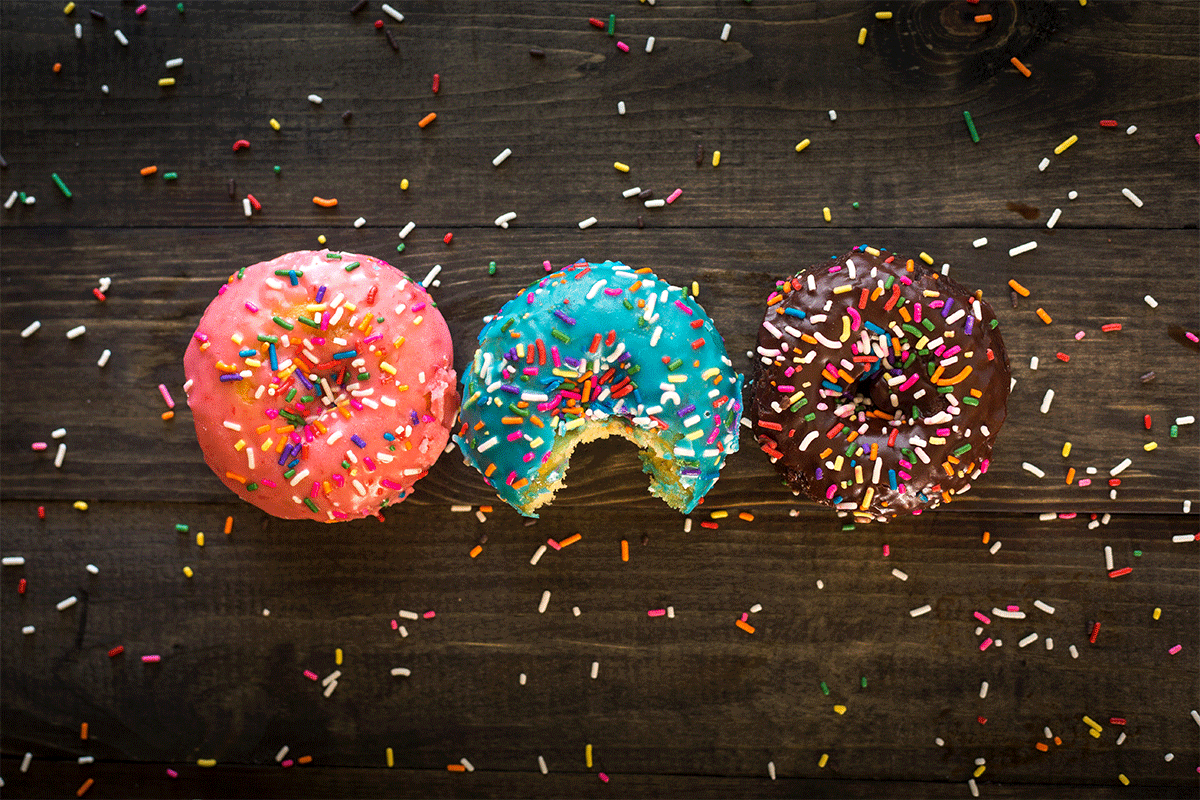 sprinkled doughnuts on a wooden table