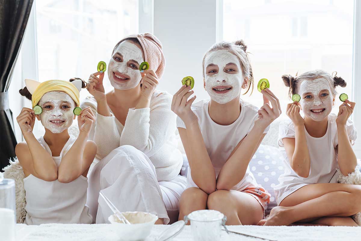 family at spa together with face masks on