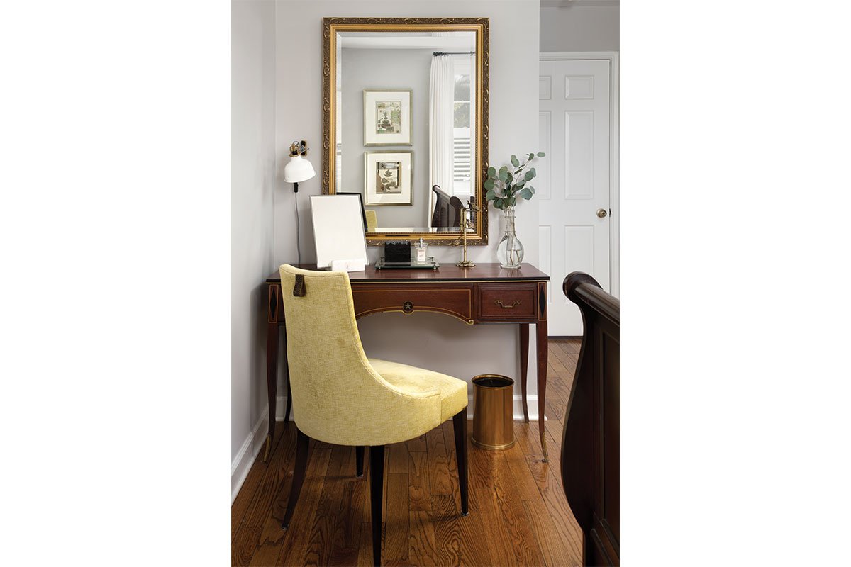 yellow chair with desk and mirror behind it