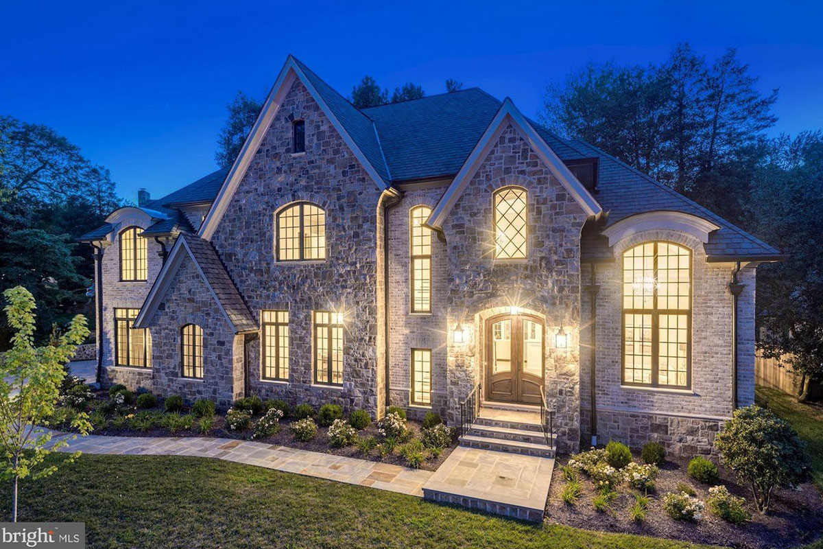 big stone house with lights at night in arlington virginia