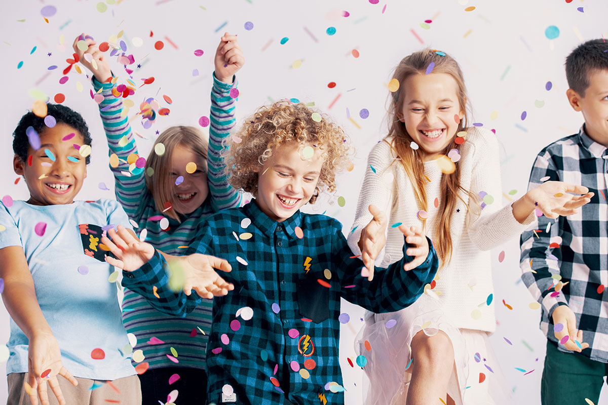 kids throwing confetti on white background