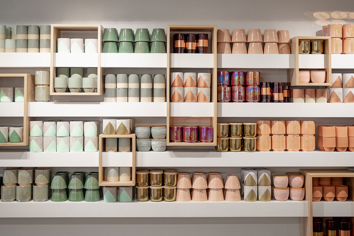 green, pink and neutral jars on shelves