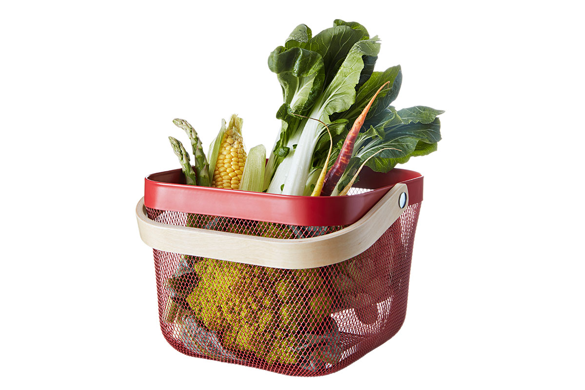 red basket with vegetables in it