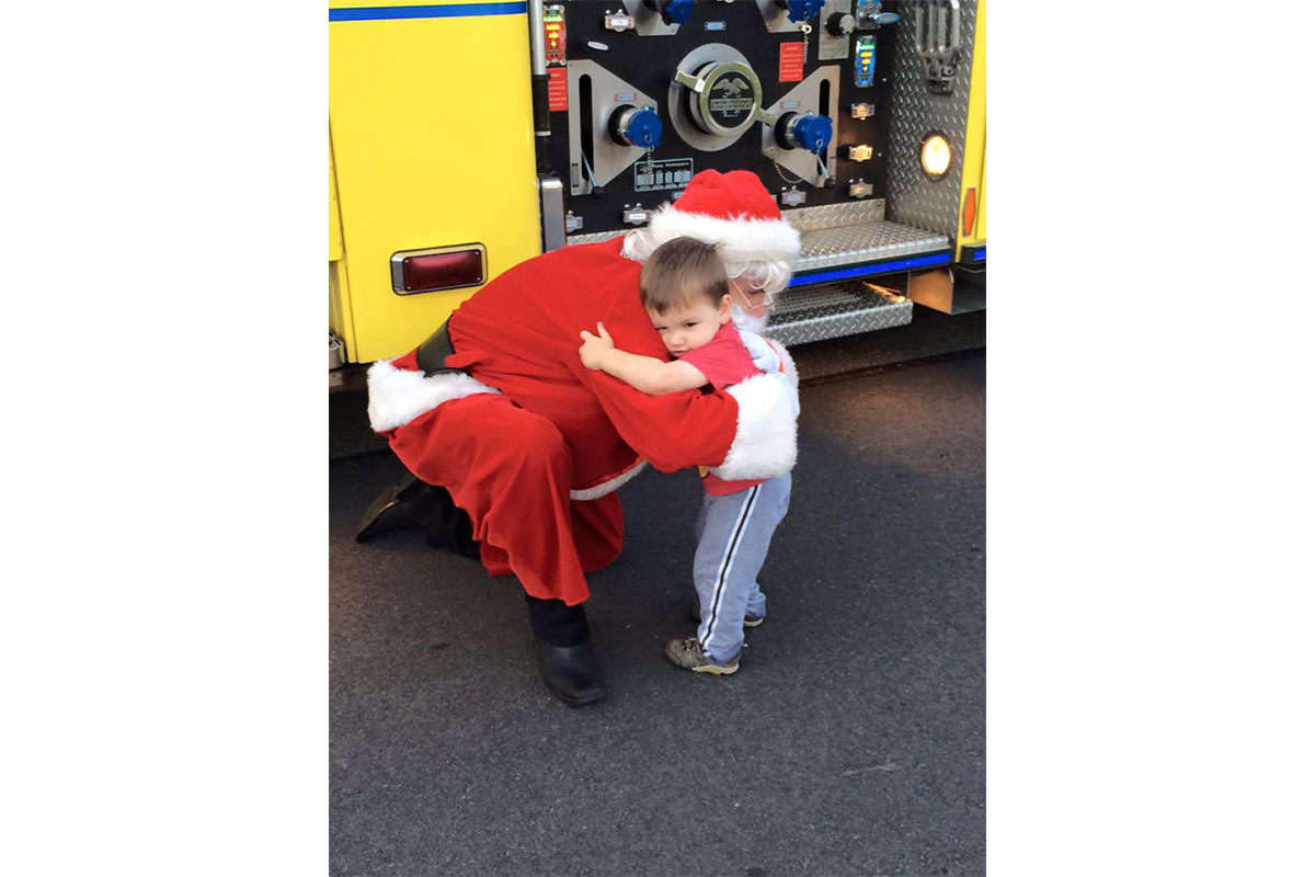 little boy hugging santa claus