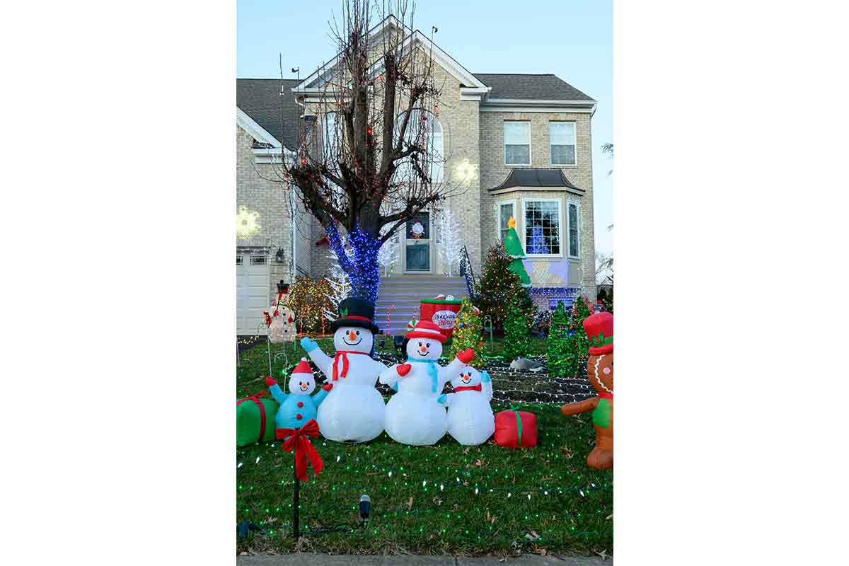 snowmen display in front of house for the holiday season