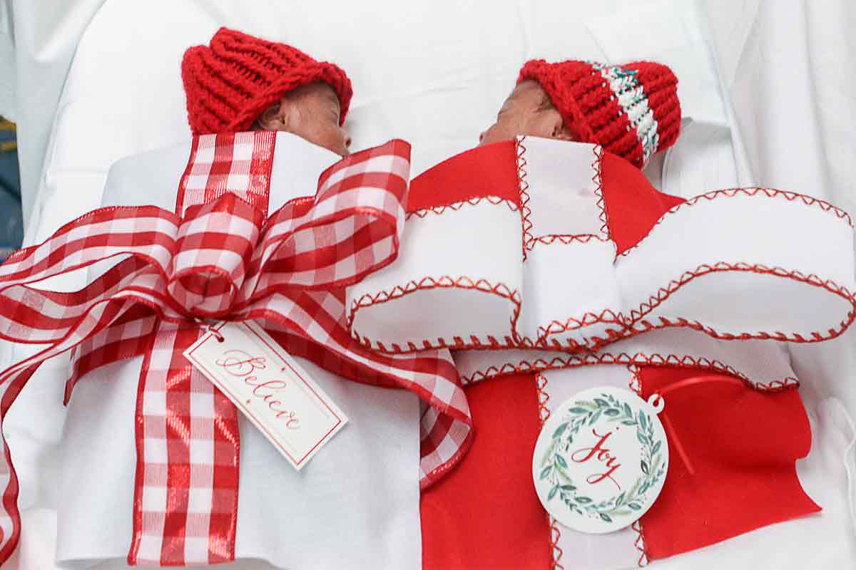 twins wrapped up as presents for a holiday photoshoot