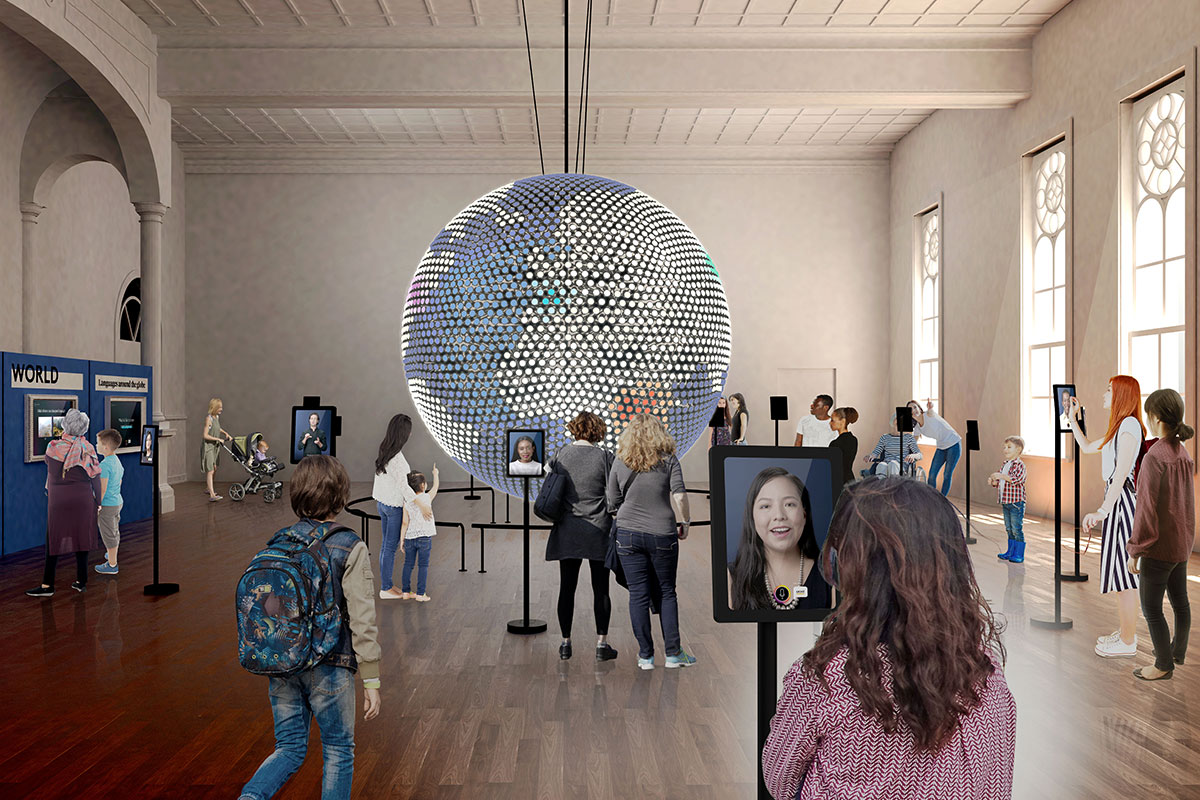 large globe hanging from ceiling with people around and screens planet word rendering
