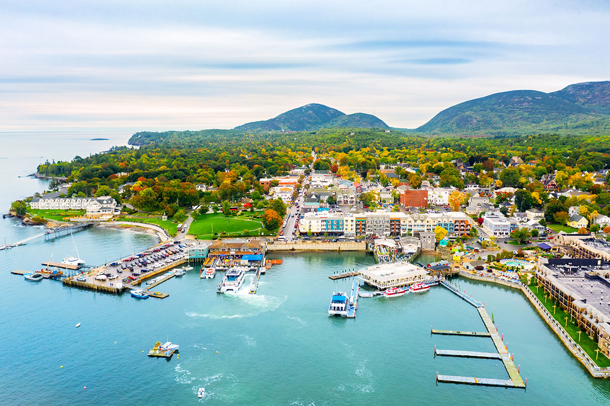 bright blue water and city of bar harbor with mountains in the back