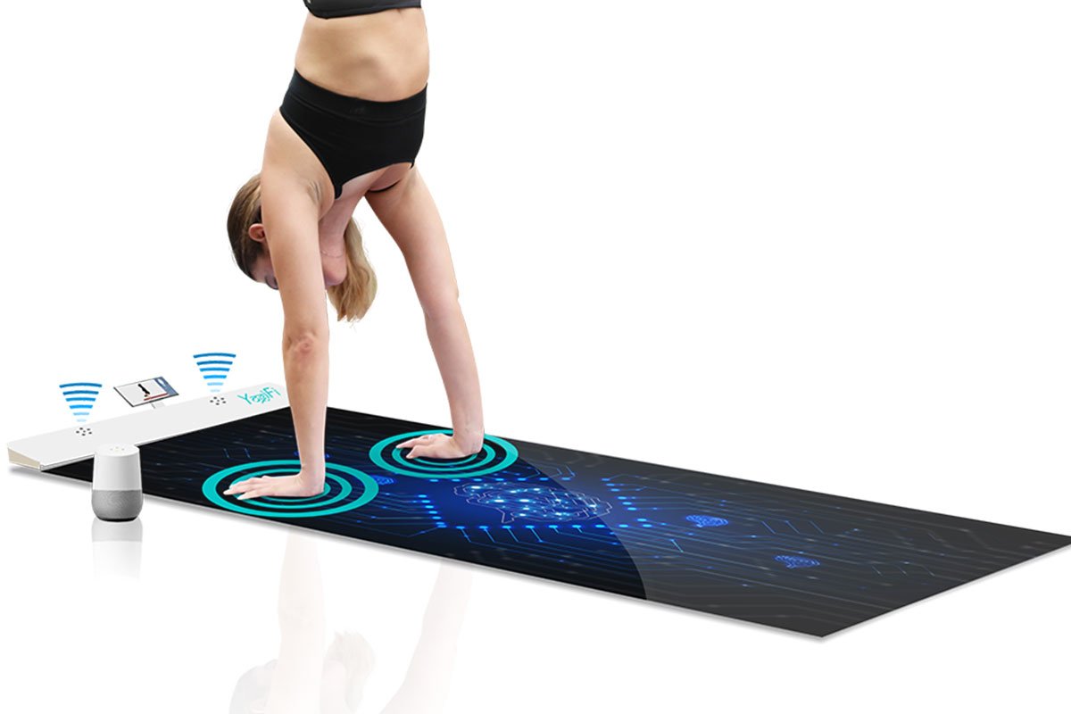 woman doing handstand on yoga mat