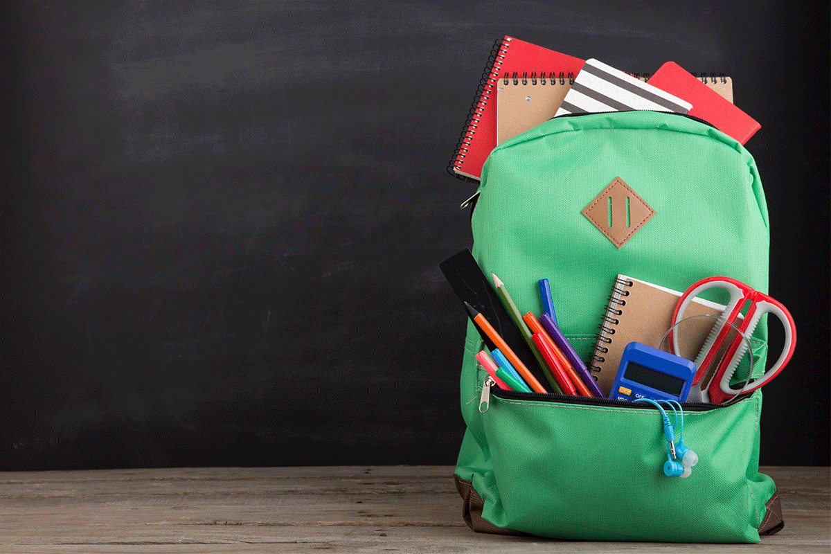 green backpack full of school supplies