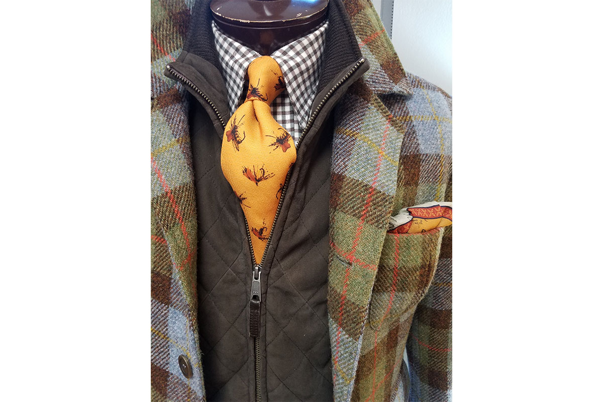 orange tie paired with a plaid jacket