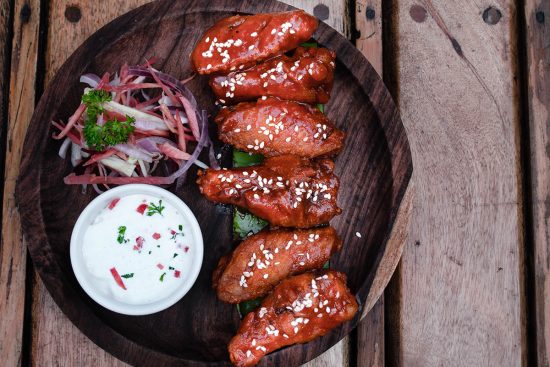 chicken wings on plate with a side of ranch dressing