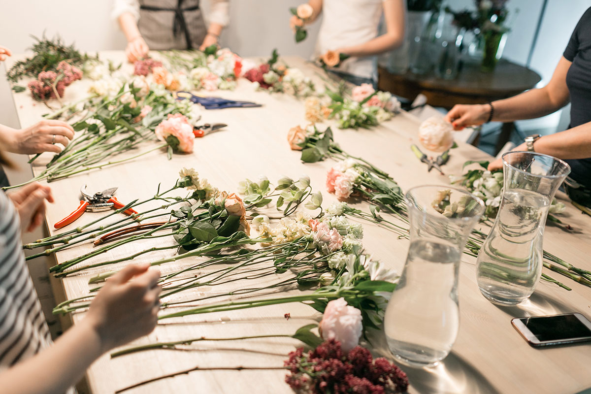 flower arranging class with women and pink flowers