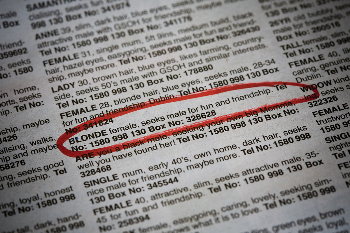 newspaper listing of women and men as potential dates with a red circle