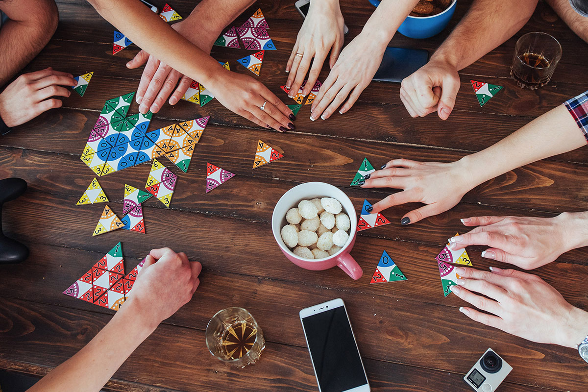 bunch of hands playing games at a table