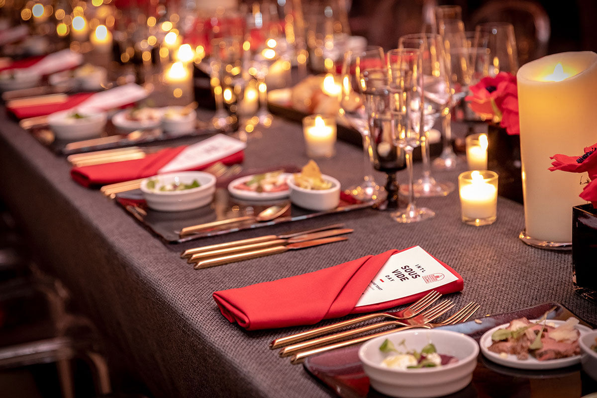 table setting with red napkins and gold silverware