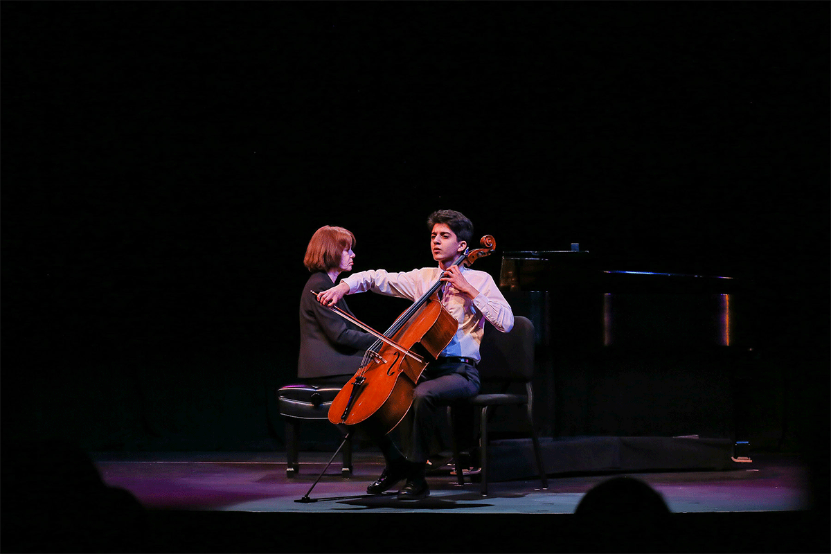 high school student boy playing cello