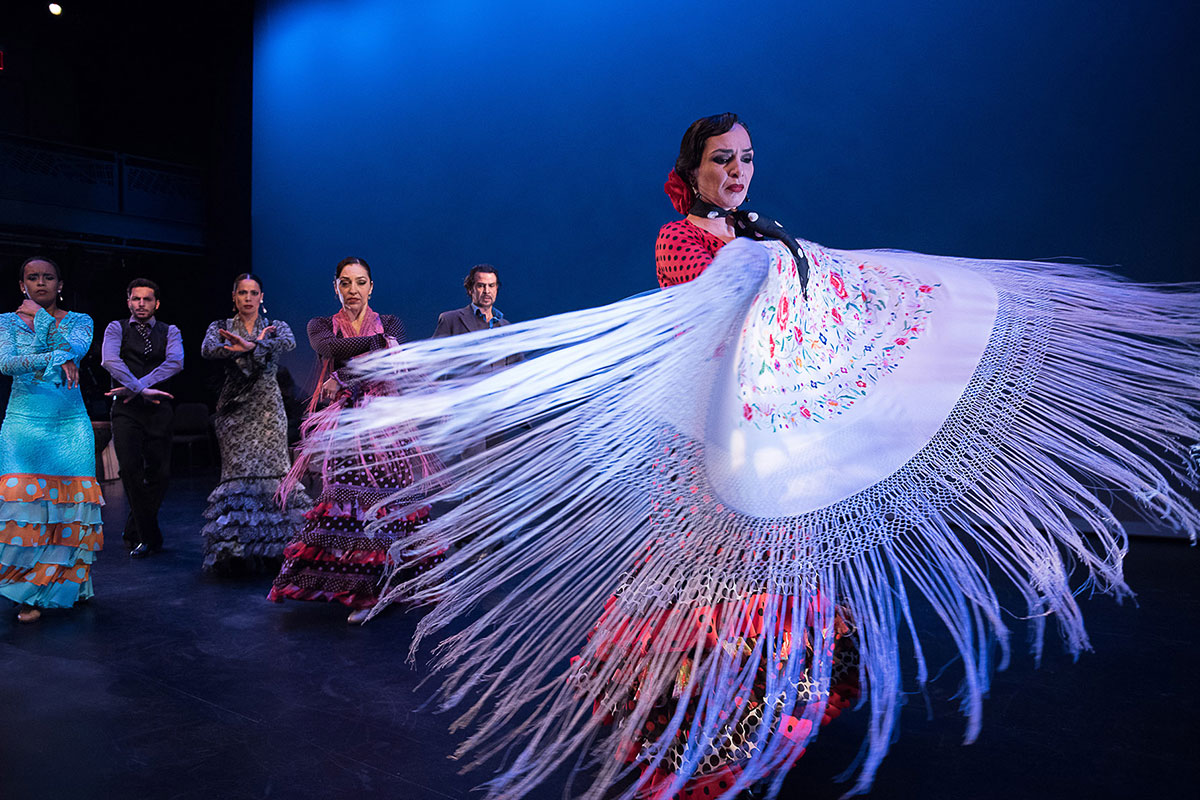 woman with white shawl doing flamenco