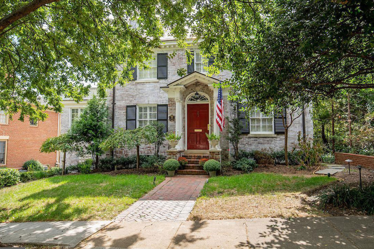 home in alexandria with red door and american flag outside