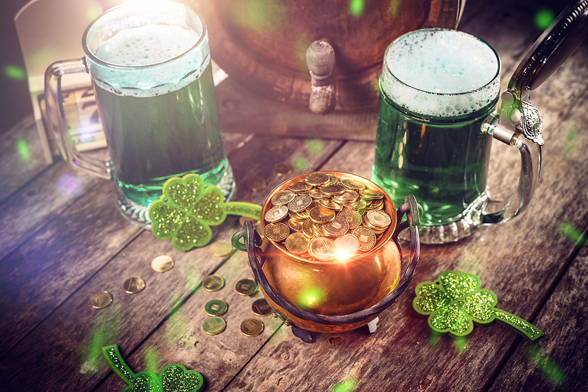 two glasses of green beer with pot of gold