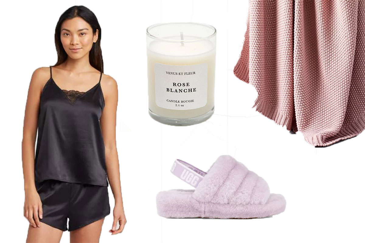 black silk pajamas with white rose candle and pink knit blanket with fluffy slippers