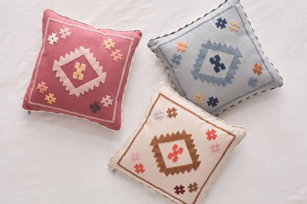 three bohemian-themed pillows