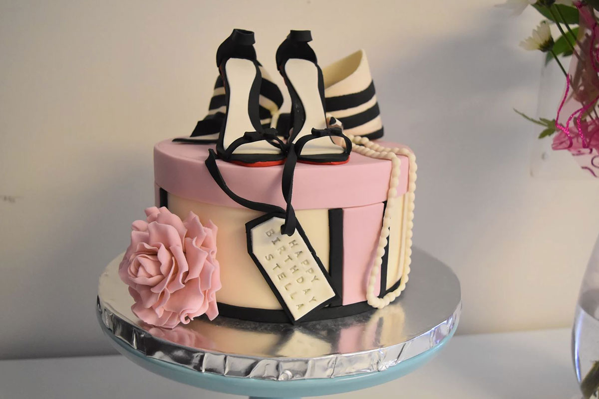pink cake with shoes on top