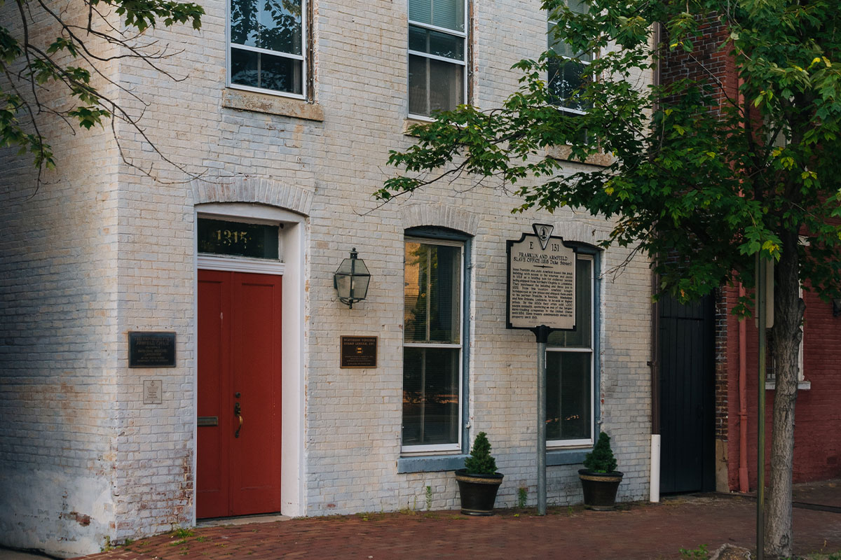 freedom house museum exterior with white brick and red door