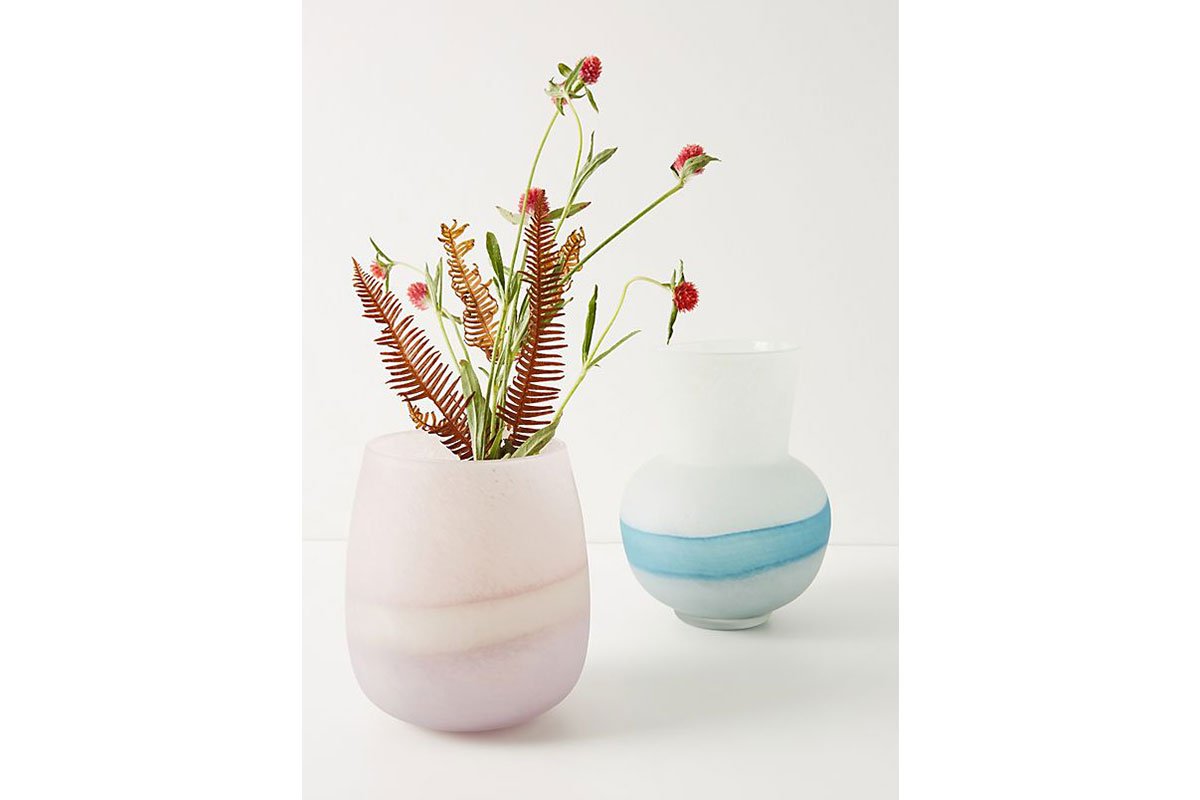 pink glass vase with flowers and blue glass vase