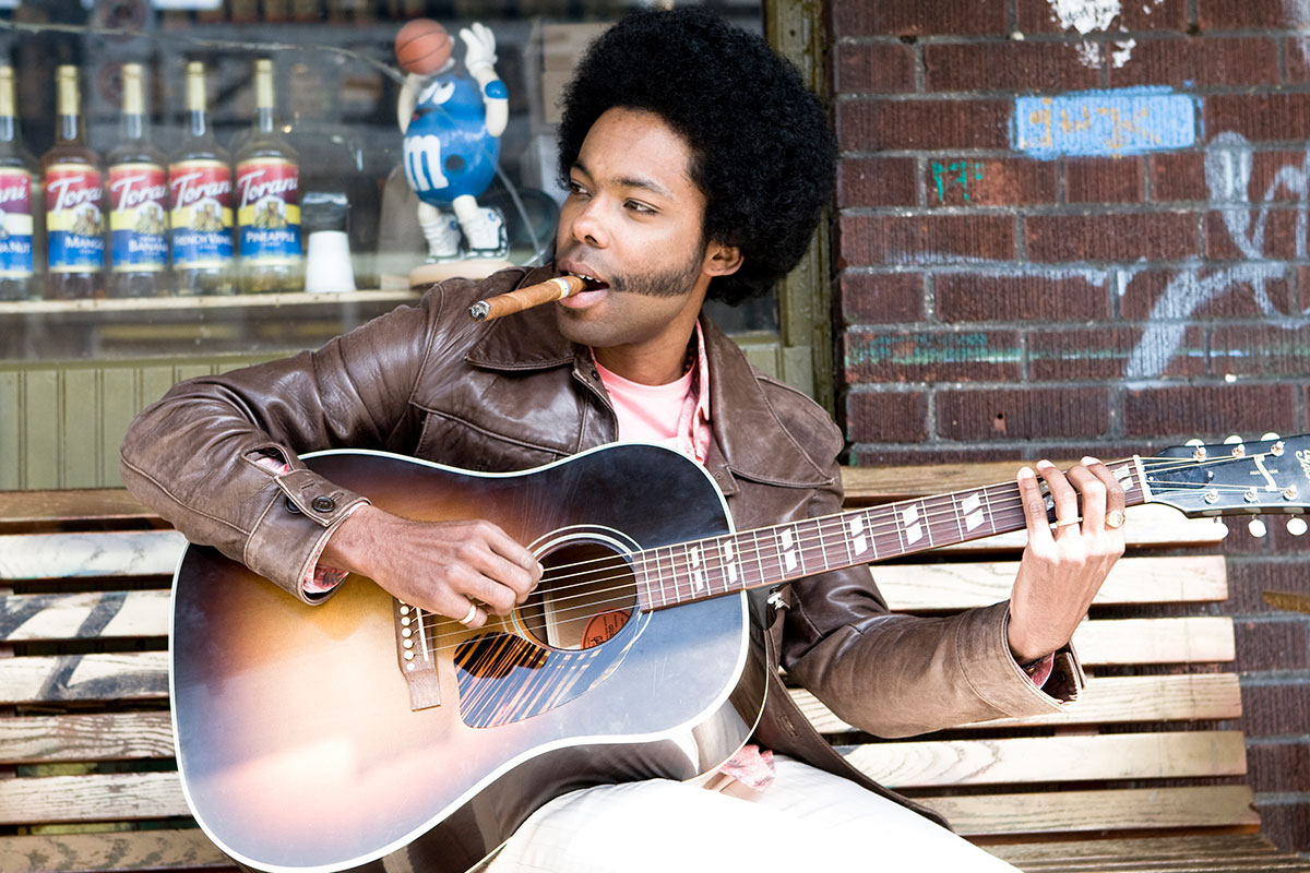 man with cigar playing guitar
