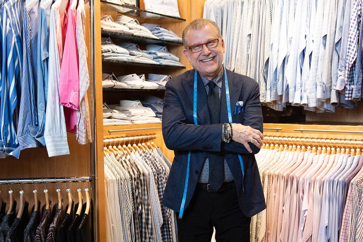 david eiselle standing in front of clothing