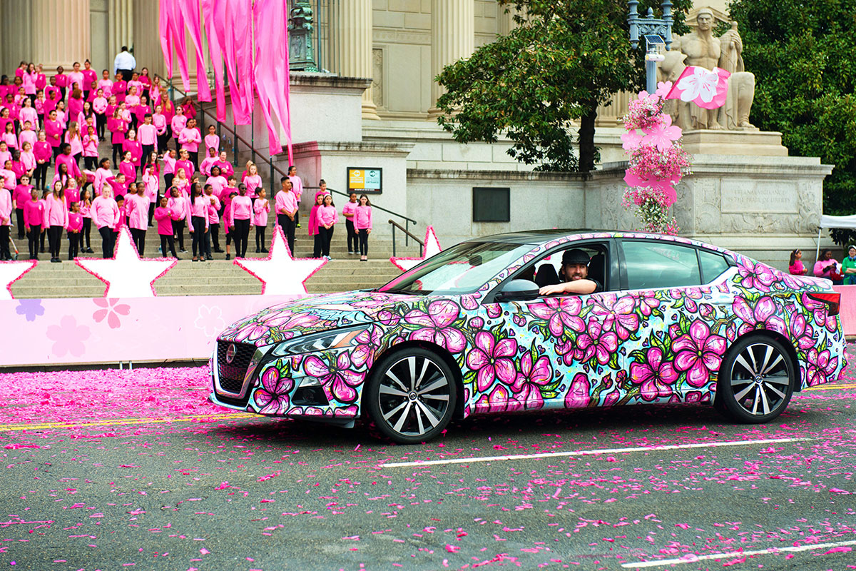man in floral-painted car