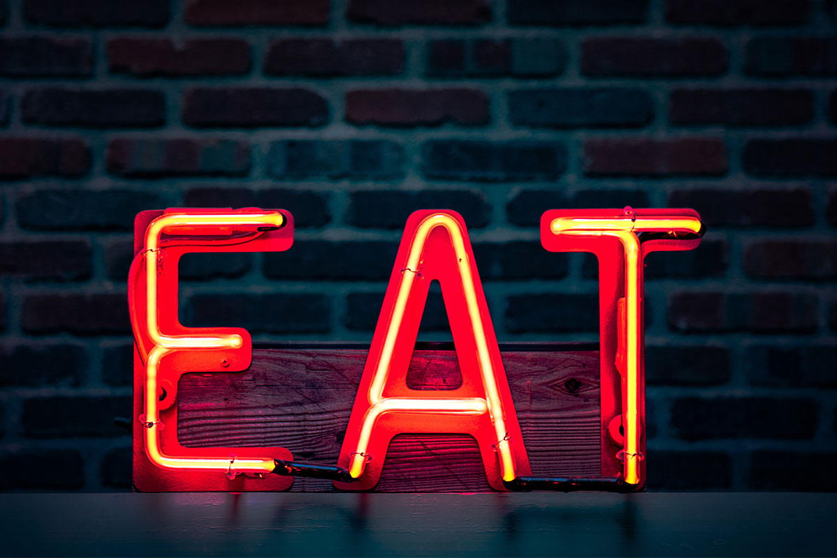 red neon light sign that says eat